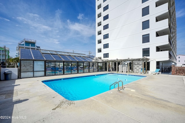 view of pool with a pergola and a patio area