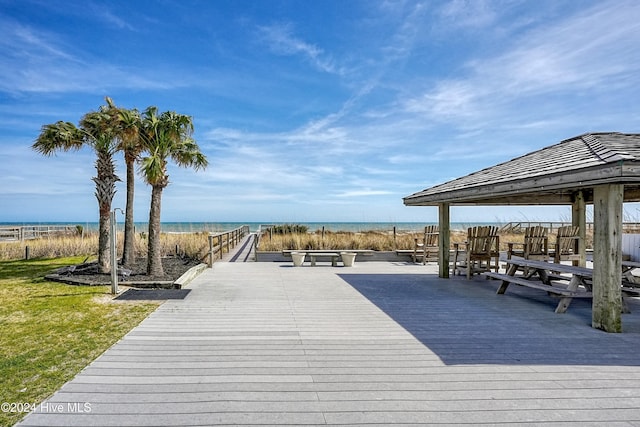 view of dock featuring a gazebo and a water view