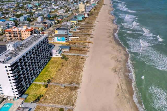 birds eye view of property with a view of the beach and a water view