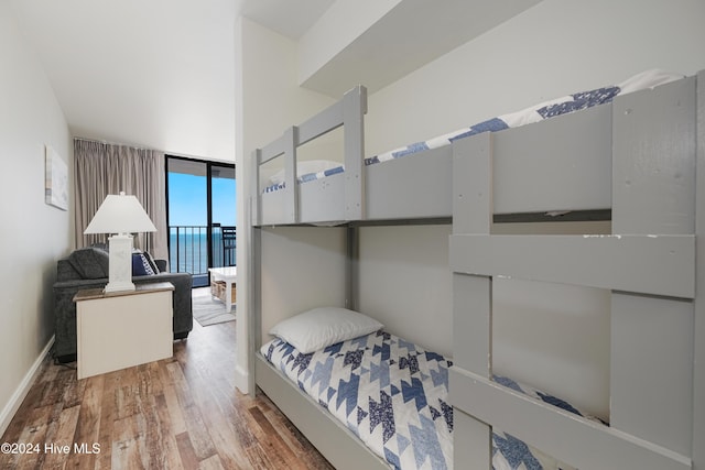 1615 Lake Park Blvd S Unit 1007, Carolina Beach, NC 28428 - bedroom with wood finished floors, access to outside, and expansive windows