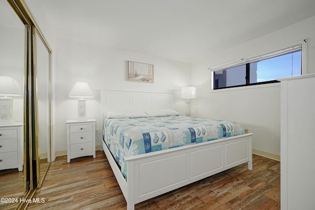 bedroom with dark wood-type flooring