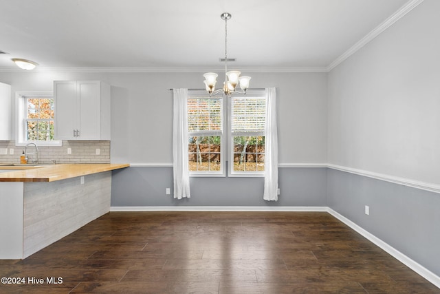 interior space with butcher block countertops, plenty of natural light, white cabinetry, and hanging light fixtures