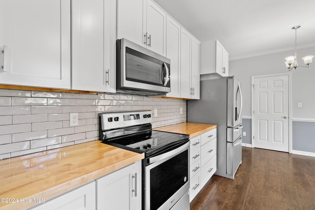 kitchen featuring stainless steel appliances, dark hardwood / wood-style floors, a notable chandelier, pendant lighting, and white cabinets