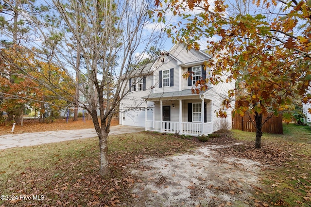 view of front of house with covered porch and a garage