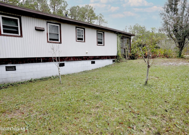 view of property exterior with a lawn