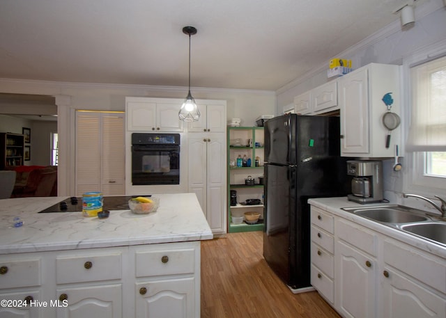 kitchen with white cabinets, pendant lighting, and black appliances