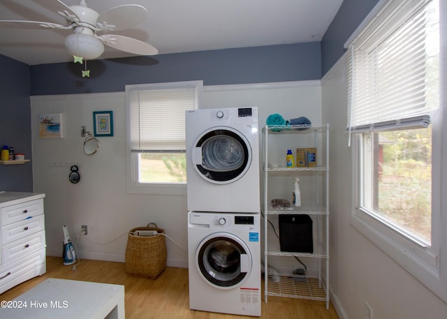 clothes washing area featuring ceiling fan, light hardwood / wood-style floors, and stacked washer / drying machine