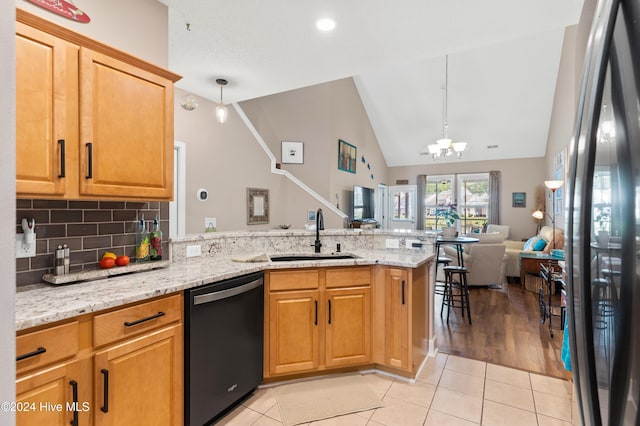 kitchen featuring lofted ceiling, sink, light tile patterned floors, kitchen peninsula, and black appliances