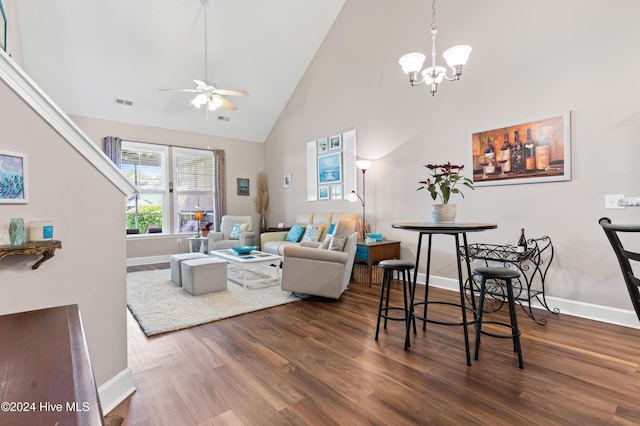 living room featuring high vaulted ceiling, ceiling fan with notable chandelier, and dark hardwood / wood-style flooring