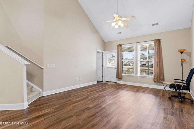 interior space featuring dark wood-type flooring, high vaulted ceiling, and ceiling fan