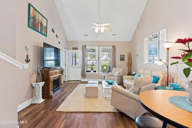 living room featuring dark hardwood / wood-style flooring, high vaulted ceiling, and ceiling fan