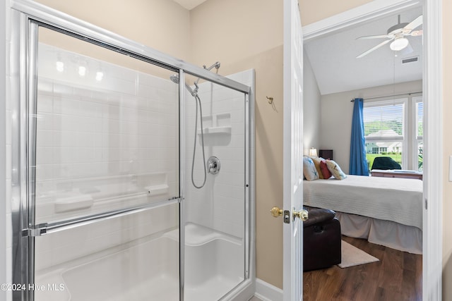 bathroom with hardwood / wood-style flooring, ceiling fan, and walk in shower