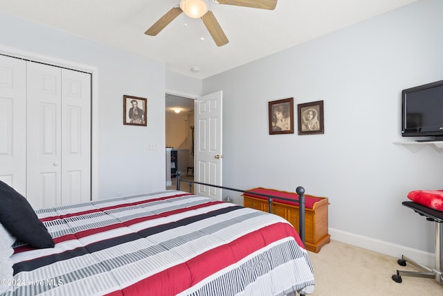 carpeted bedroom featuring ceiling fan and a closet