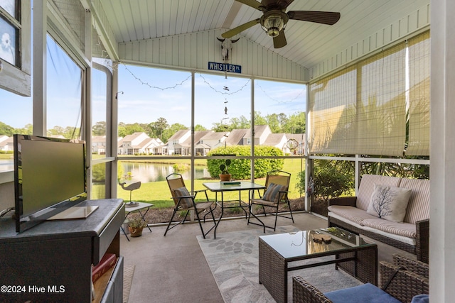 sunroom featuring ceiling fan and lofted ceiling