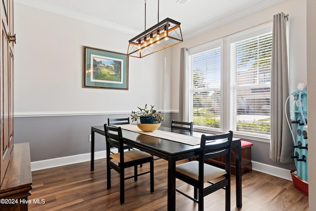 dining area featuring ornamental molding and dark hardwood / wood-style floors