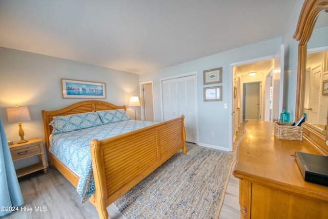 bedroom featuring a closet and light wood-type flooring