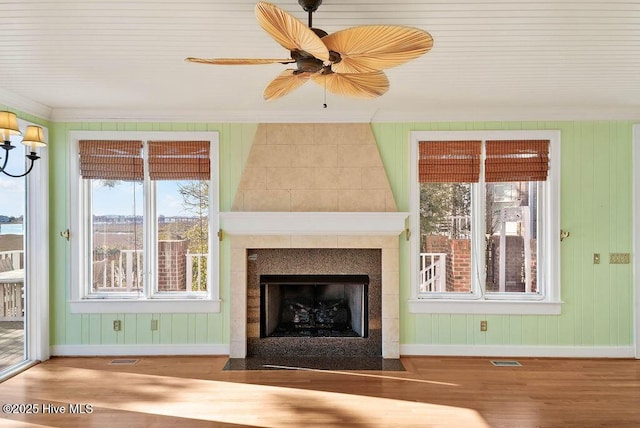 unfurnished living room featuring a large fireplace and wood-type flooring