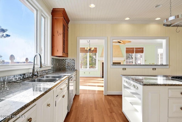 kitchen featuring stone counters, white cabinets, crown molding, sink, and light hardwood / wood-style flooring