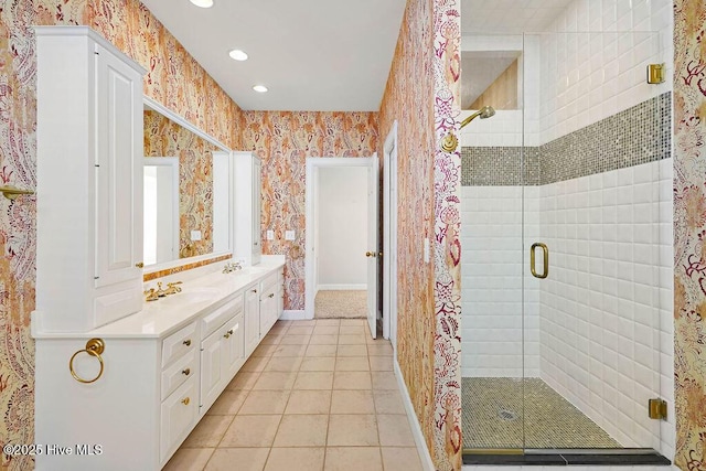 bathroom featuring tile patterned flooring, vanity, and walk in shower