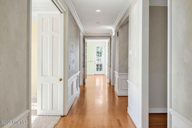 corridor featuring light hardwood / wood-style flooring and ornamental molding