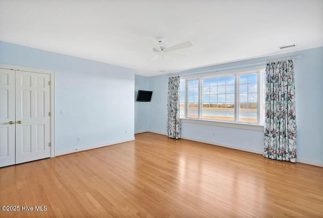 unfurnished room with ceiling fan and light hardwood / wood-style floors