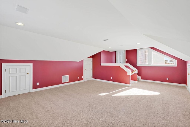 bonus room with carpet floors and vaulted ceiling