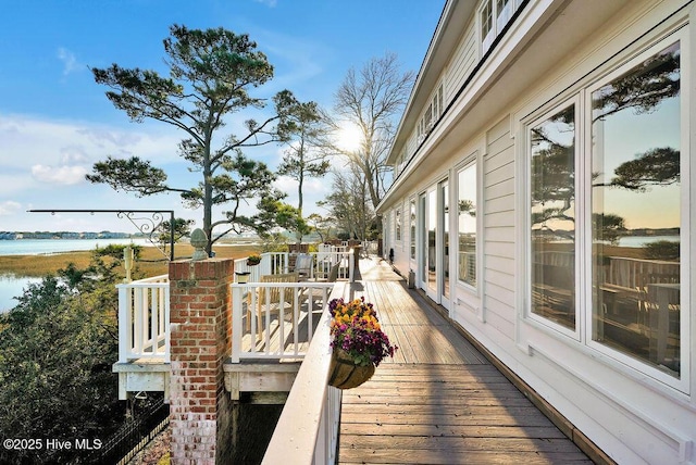 wooden terrace with a water view