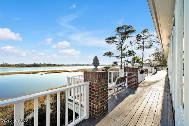 wooden terrace featuring a water view