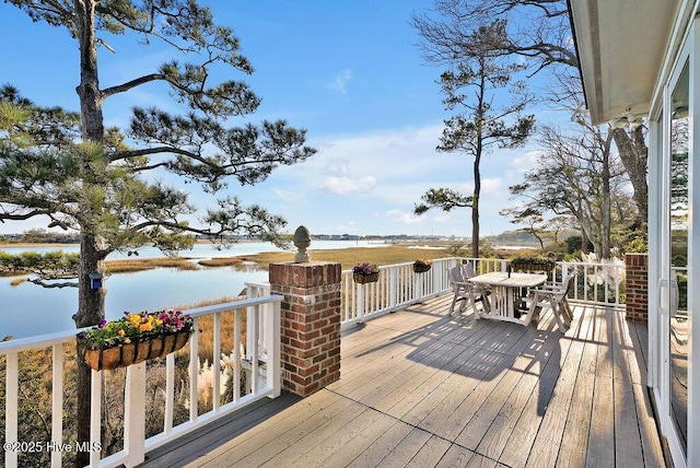 wooden terrace featuring a water view