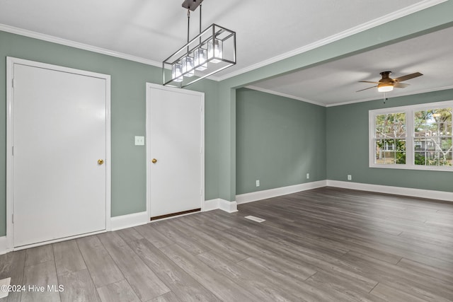 interior space featuring hardwood / wood-style floors, ceiling fan, and crown molding