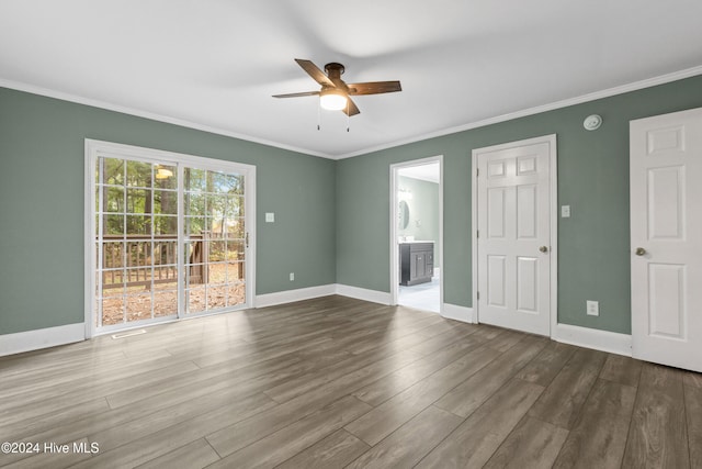 empty room featuring hardwood / wood-style floors, ceiling fan, and crown molding