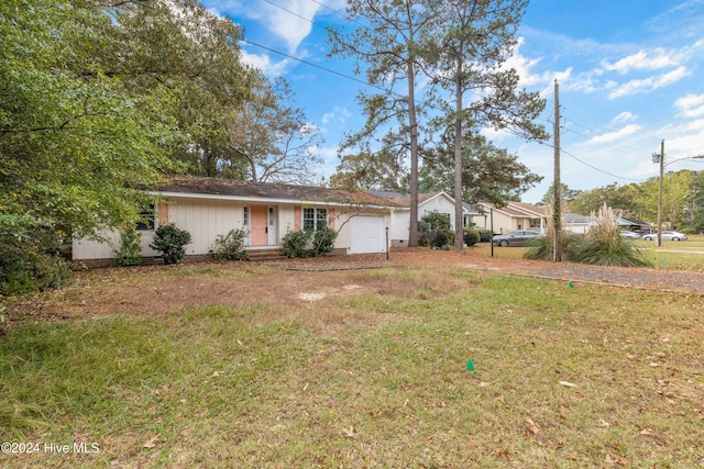 single story home featuring a front yard and a garage