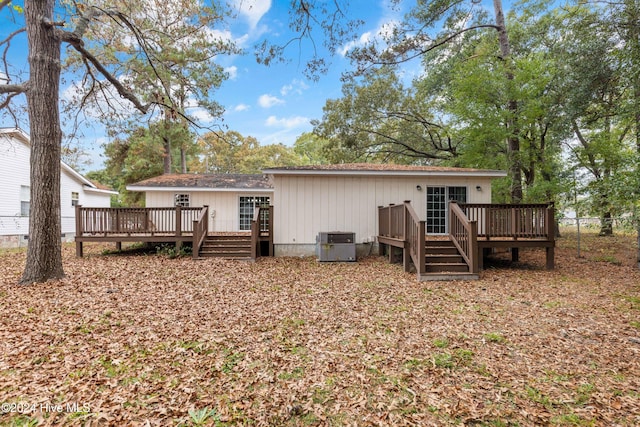 back of house with central air condition unit and a wooden deck