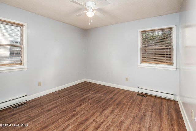 spare room featuring dark hardwood / wood-style floors, ceiling fan, and a baseboard radiator