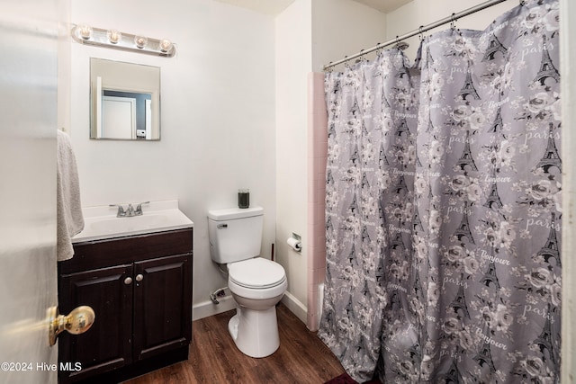 bathroom featuring hardwood / wood-style floors, vanity, toilet, and walk in shower