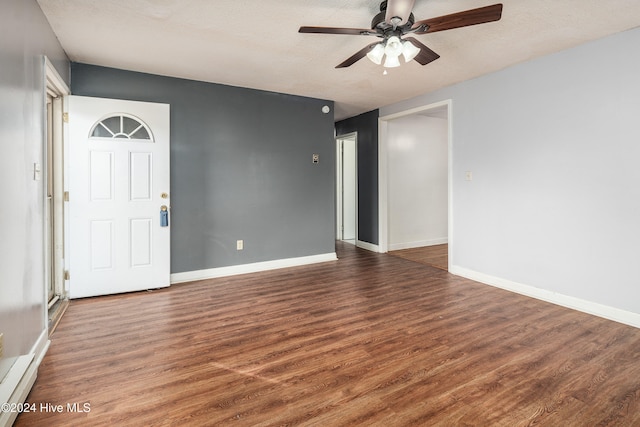 entrance foyer featuring ceiling fan, dark hardwood / wood-style flooring, and a textured ceiling