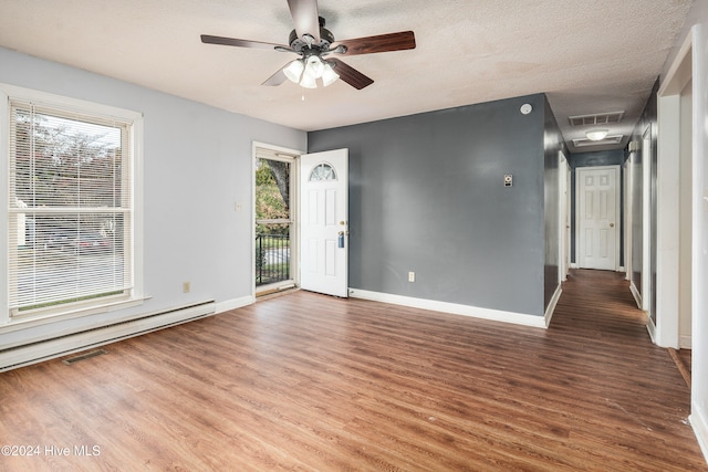 empty room featuring ceiling fan, wood-type flooring, and a textured ceiling