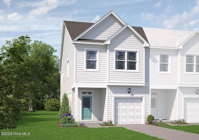 view of property with a front lawn and a garage