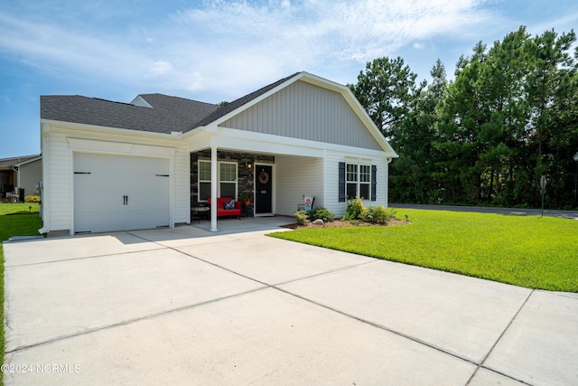 view of front of property featuring driveway, an attached garage, and a front yard