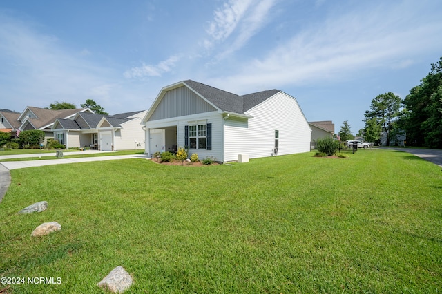 view of side of home with a yard