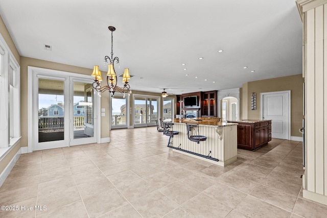 10108 Sea Breeze Dr, Emerald Isle, NC 28594 - kitchen featuring open floor plan, a large island with sink, plenty of natural light, a kitchen bar, and recessed lighting