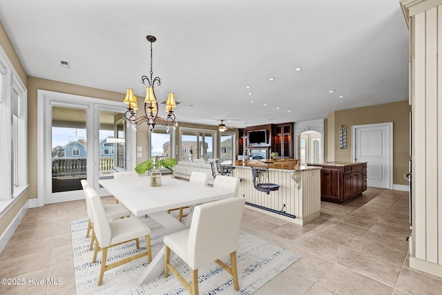 10108 Sea Breeze Dr, Emerald Isle, NC 28594 - dining space featuring light tile patterned floors, plenty of natural light, recessed lighting, and a chandelier