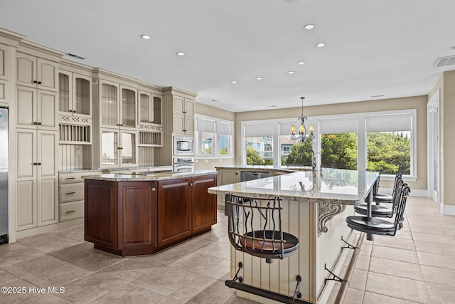 10108 Sea Breeze Dr, Emerald Isle, NC 28594 - kitchen with a spacious island, cream cabinets, stainless steel appliances, recessed lighting, and healthy amount of natural light