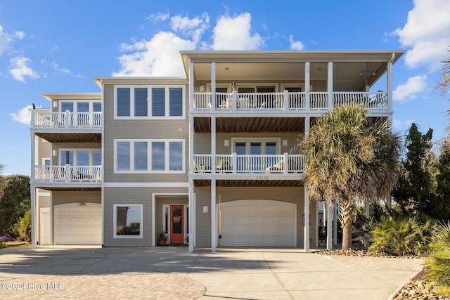10108 Sea Breeze Dr, Emerald Isle, NC 28594 - coastal home featuring an attached garage, concrete driveway, and a balcony