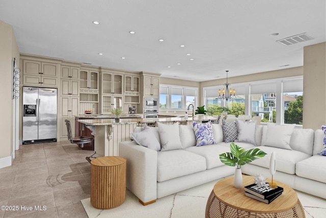 10108 Sea Breeze Dr, Emerald Isle, NC 28594 - living room featuring a chandelier, recessed lighting, and light tile patterned floors