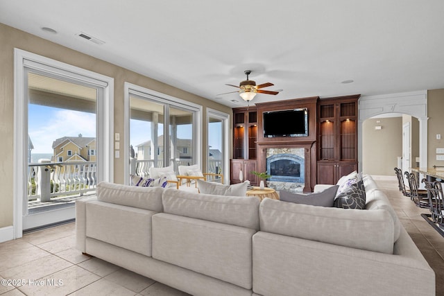 10108 Sea Breeze Dr, Emerald Isle, NC 28594 - living room with a ceiling fan, healthy amount of natural light, arched walkways, and a high end fireplace