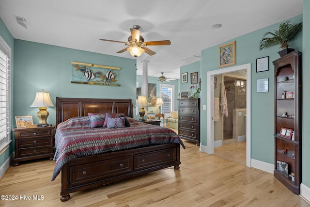 bedroom with ceiling fan, light wood-type flooring, and connected bathroom