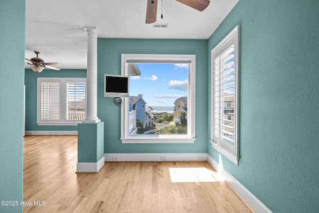10108 Sea Breeze Dr, Emerald Isle, NC 28594 - spare room with a ceiling fan, decorative columns, wood finished floors, and a textured wall