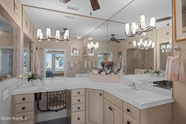 bathroom with vanity and ceiling fan with notable chandelier