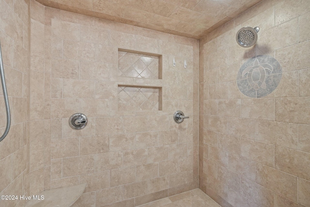 bathroom with tiled shower